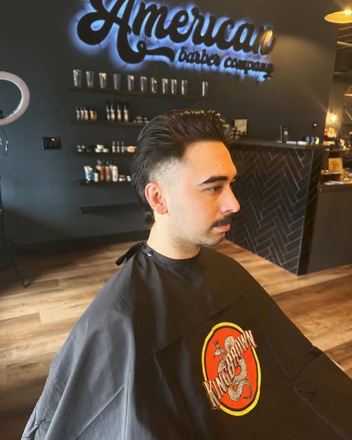 Client with a slicked-back scissor cut and shaped moustache
